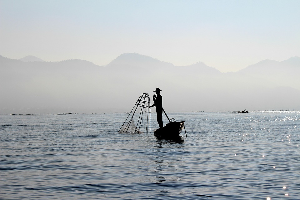 Fisherman with mountains in background